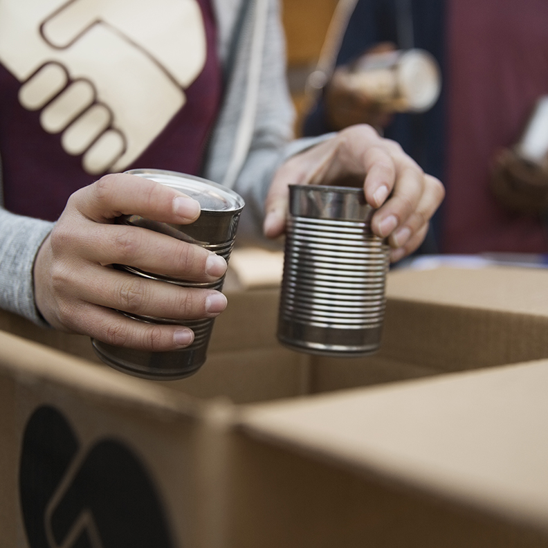 INSIGHT IMAGE / BUSINESS non profit hands boxing cans