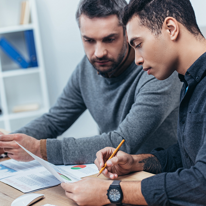 Insight Image > Two men reviewing paperwork 792x792