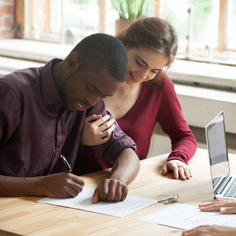 DiverseCouple SigningPaperwork 792x792