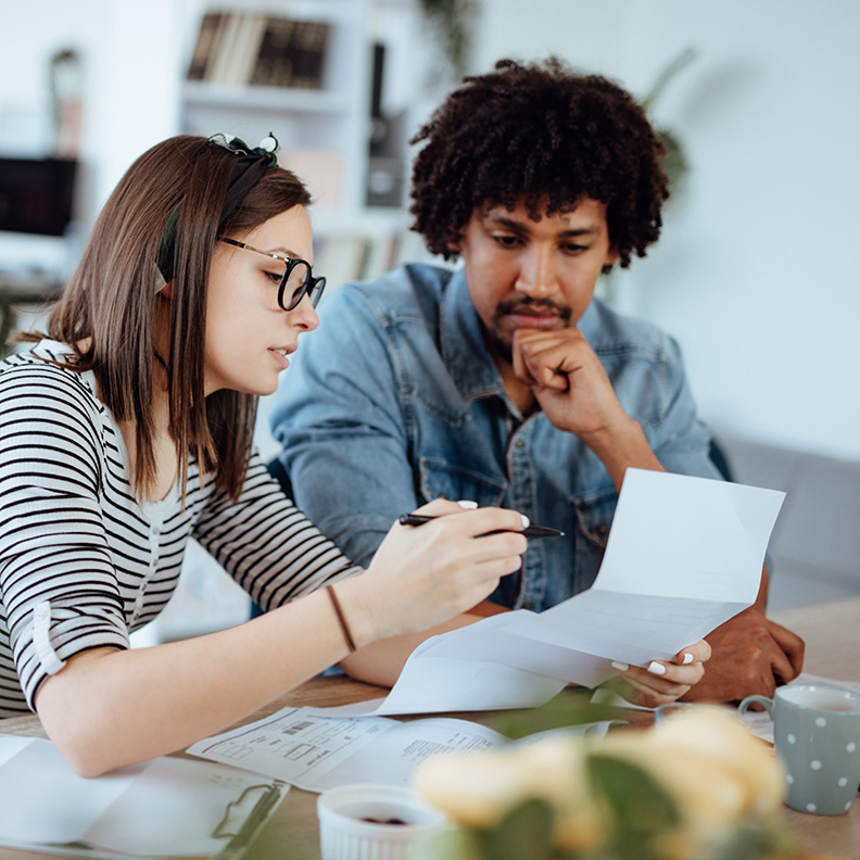 Diverse YoungCouple reviewingpaperwork 792x792